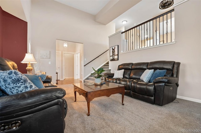 living room featuring stairway, baseboards, and carpet floors