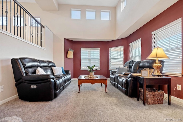 living area featuring carpet flooring, baseboards, and a wealth of natural light