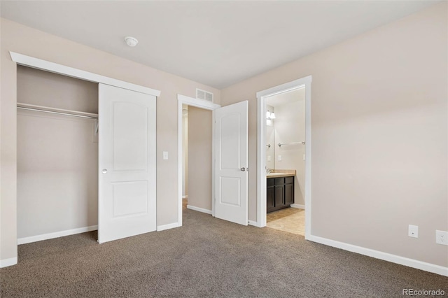 unfurnished bedroom with visible vents, baseboards, carpet, and a closet