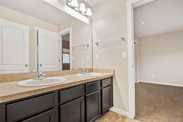 full bathroom featuring double vanity, baseboards, and a sink