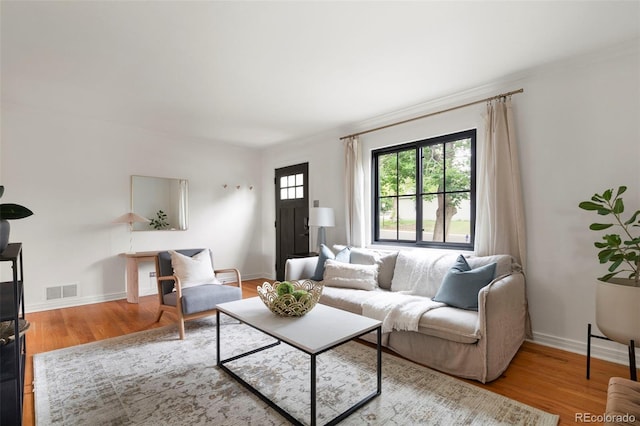 1411 S Beach Ct, Denver, CO 80219 - living area featuring wood finished floors, crown molding, and baseboards