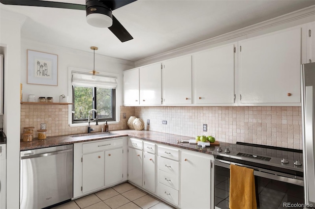 1411 S Beach Ct, Denver, CO 80219 - kitchen with appliances with stainless steel finishes, a sink, a ceiling fan, decorative backsplash, and ornamental molding