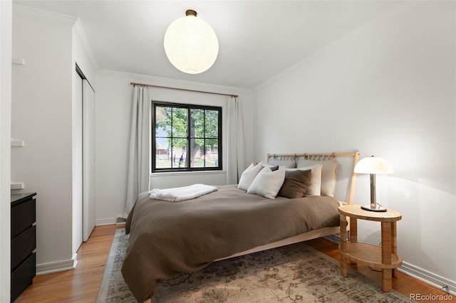 1411 S Beach Ct, Denver, CO 80219 - bedroom with crown molding, light wood-style floors, baseboards, and a closet