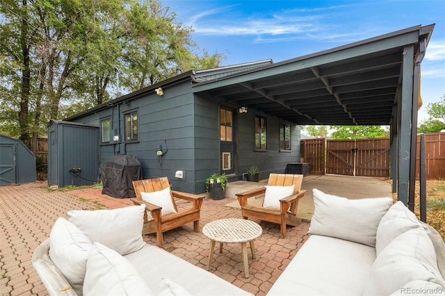 1411 S Beach Ct, Denver, CO 80219 - view of patio with outdoor lounge area, a gate, a grill, and a carport