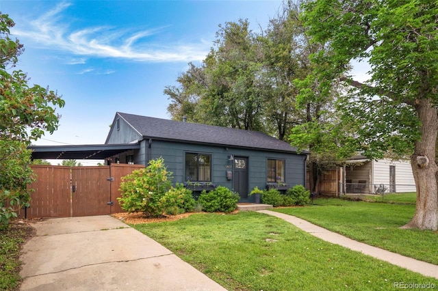1411 S Beach Ct, Denver, CO 80219 - view of front facade with a gate, roof with shingles, and concrete driveway