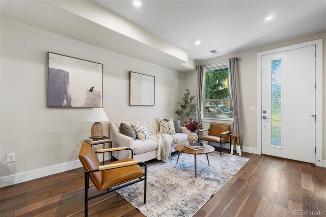 living room with dark hardwood / wood-style flooring