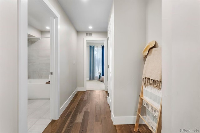 corridor with hardwood / wood-style floors