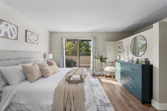 bedroom with access to outside and light hardwood / wood-style flooring