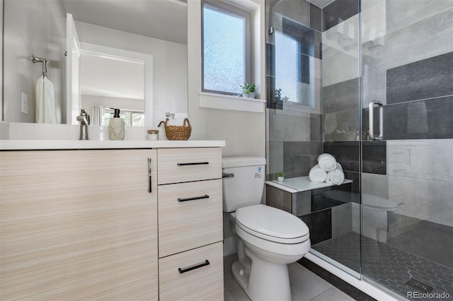 bathroom with a healthy amount of sunlight, vanity, and toilet