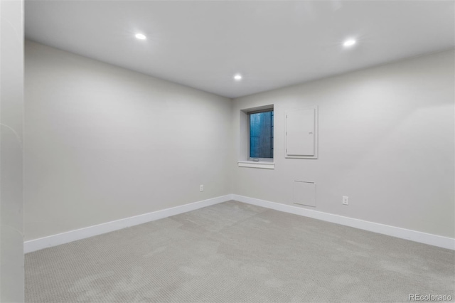 spare room with electric panel and light colored carpet