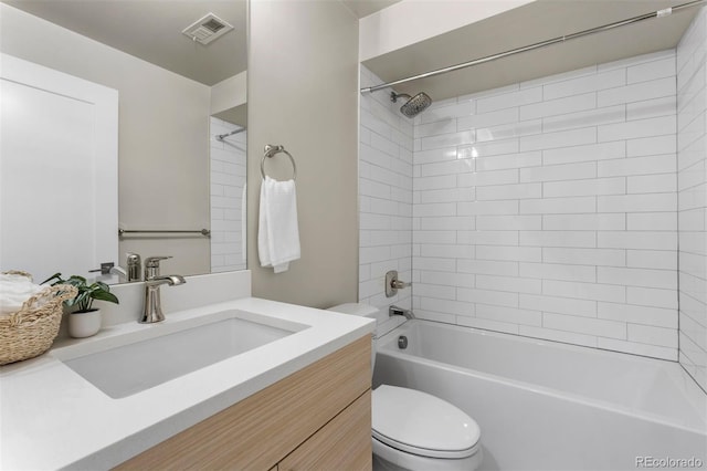 full bathroom featuring toilet, vanity, and tiled shower / bath combo