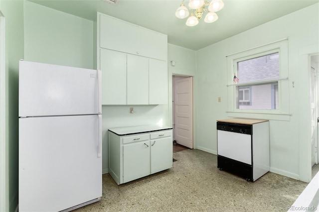 kitchen featuring white appliances, baseboards, white cabinets, and an inviting chandelier