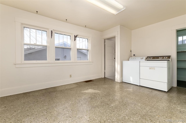 laundry area featuring laundry area, baseboards, and separate washer and dryer