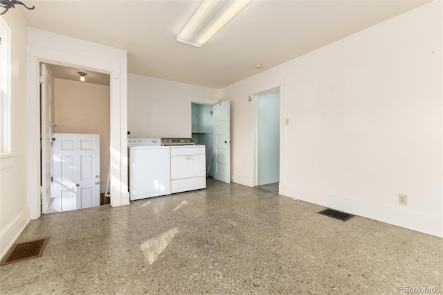 laundry room with laundry area, separate washer and dryer, visible vents, and baseboards