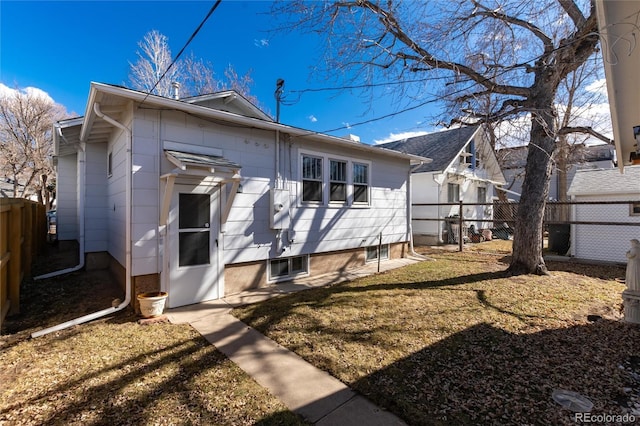 exterior space with a fenced backyard and a yard