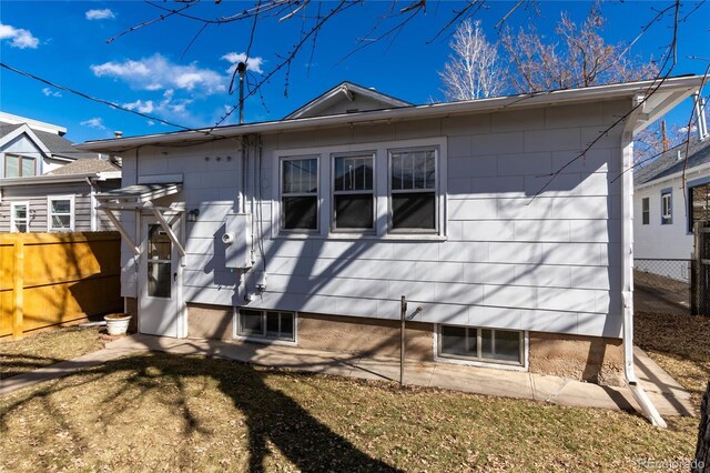 rear view of property with fence