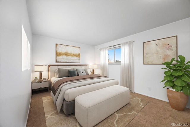 bedroom featuring baseboards and light colored carpet