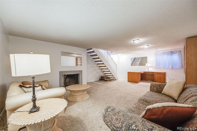 carpeted living area featuring stairway, a textured ceiling, and a fireplace