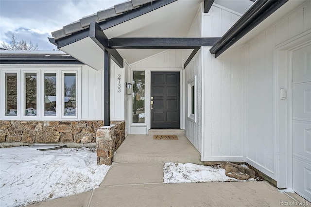 view of snow covered property entrance