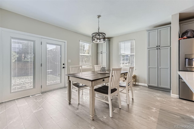 dining room featuring an inviting chandelier and light wood-type flooring