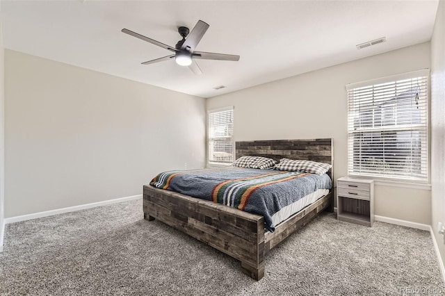 bedroom featuring carpet, multiple windows, and ceiling fan