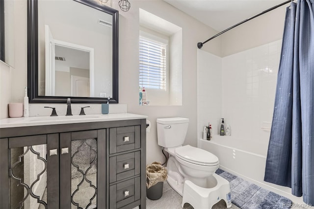 full bathroom featuring toilet, vanity, tile patterned floors, and shower / tub combo