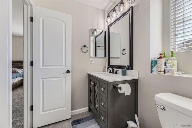 bathroom featuring toilet, vanity, and tile patterned floors