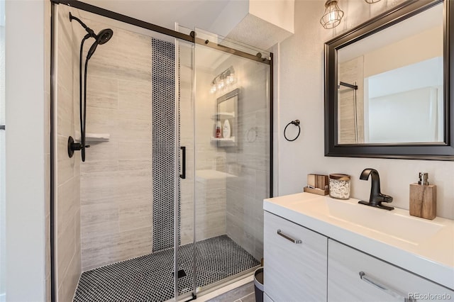 bathroom with vanity and a shower with shower door