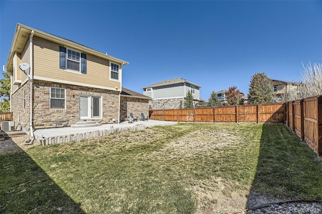 rear view of house with a yard, a patio, and cooling unit