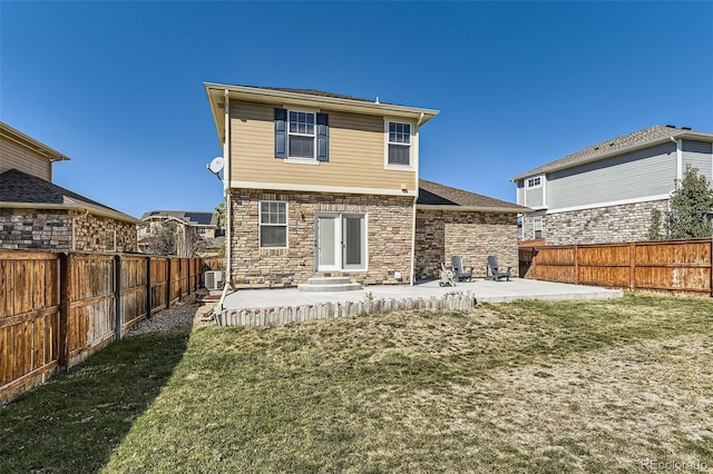 back of house featuring a patio area and a lawn