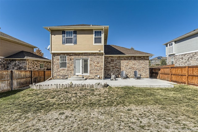 back of house with a patio area and a lawn