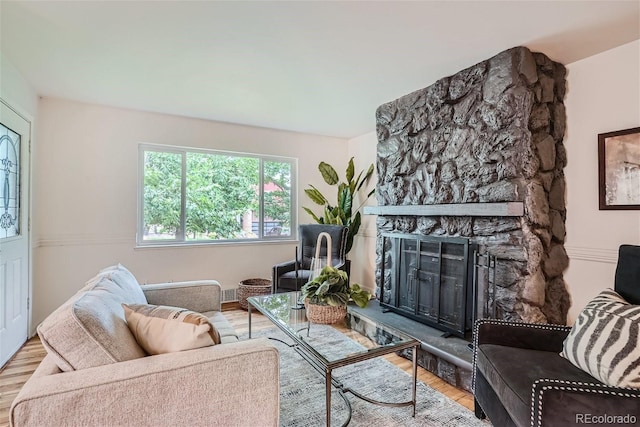 living room featuring a fireplace and light hardwood / wood-style floors