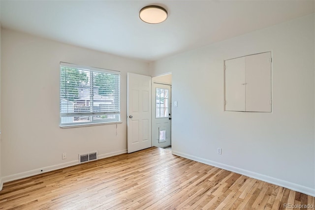 empty room with light hardwood / wood-style floors