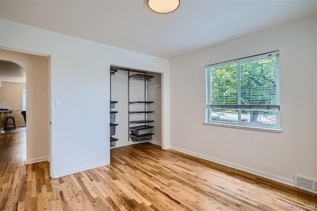 unfurnished bedroom featuring light wood-type flooring and a closet