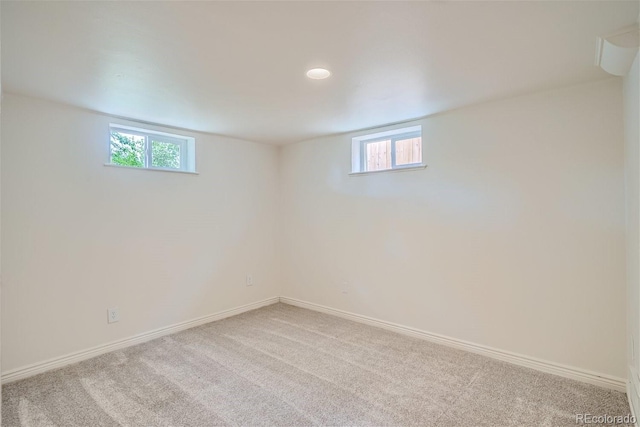 basement featuring plenty of natural light and carpet flooring