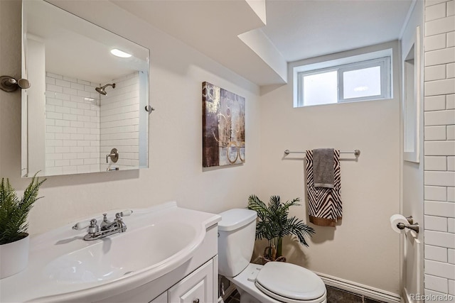 bathroom with vanity, toilet, and a tile shower