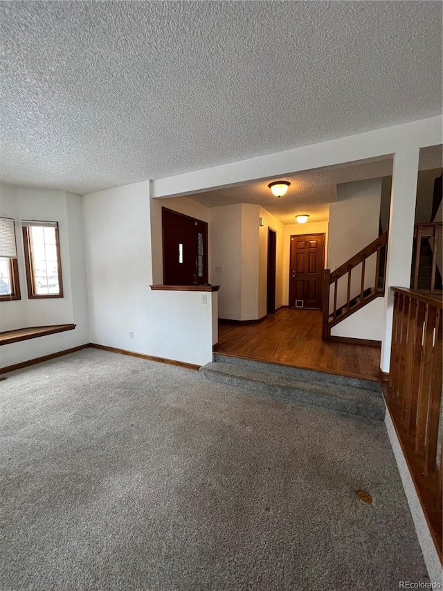 spare room featuring a textured ceiling and hardwood / wood-style flooring