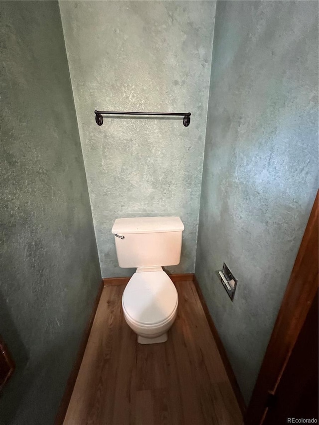 bathroom with toilet and hardwood / wood-style flooring