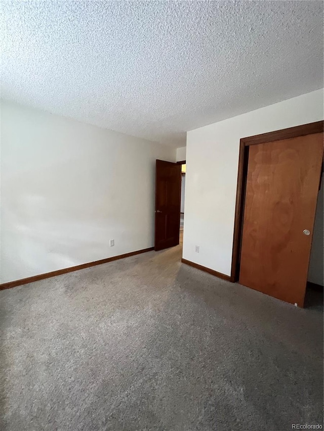 unfurnished room with a textured ceiling