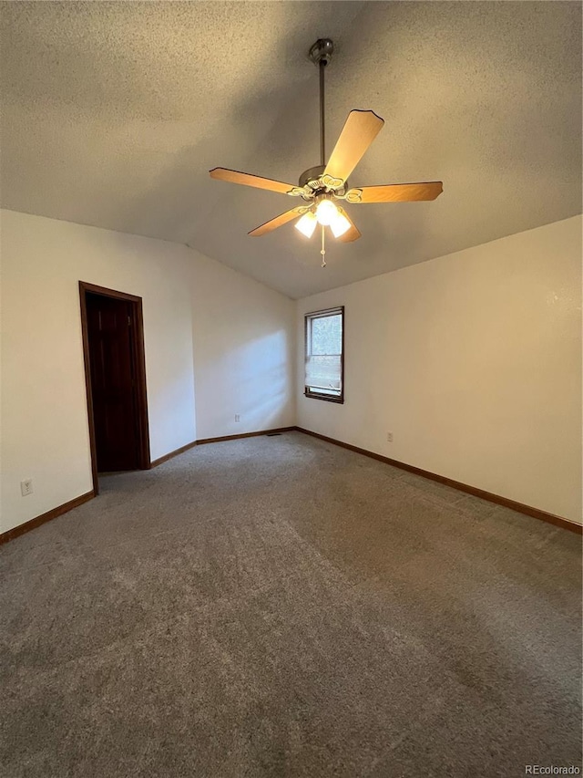 unfurnished room featuring ceiling fan, carpet, and vaulted ceiling