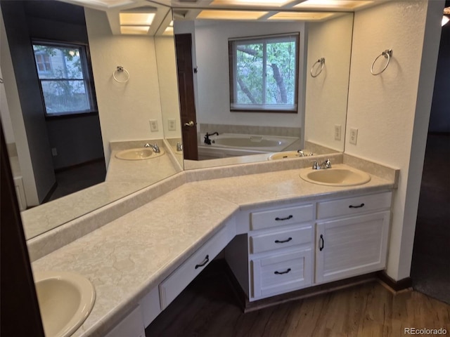 2477 S Oakland Cir, Aurora, CO 80014 - bathroom featuring double vanity, wood finished floors, and a garden tub
