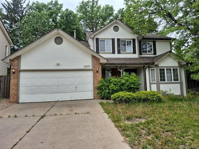 2477 S Oakland Cir, Aurora, CO 80014 - traditional-style house featuring concrete driveway, an attached garage, brick siding, and a shingled roof