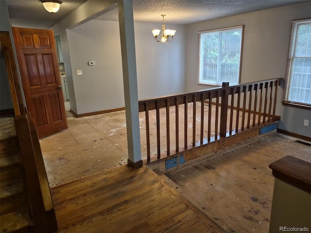 2477 S Oakland Cir, Aurora, CO 80014 - stairs featuring baseboards, a chandelier, and a textured ceiling