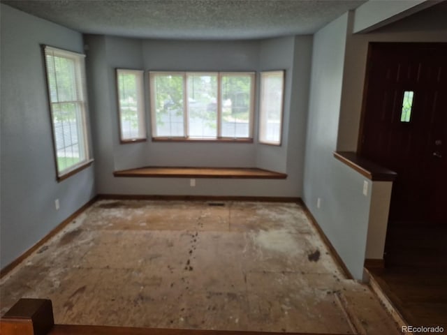 2477 S Oakland Cir, Aurora, CO 80014 - spare room with baseboards and a textured ceiling