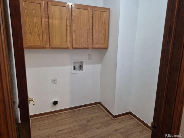 2477 S Oakland Cir, Aurora, CO 80014 - laundry area with hookup for an electric dryer, washer hookup, wood finished floors, cabinet space, and baseboards