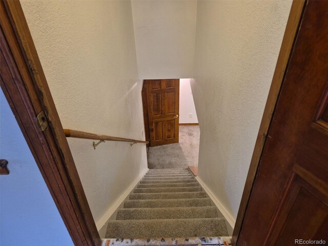 2477 S Oakland Cir, Aurora, CO 80014 - stairway with a textured wall, carpet flooring, and baseboards