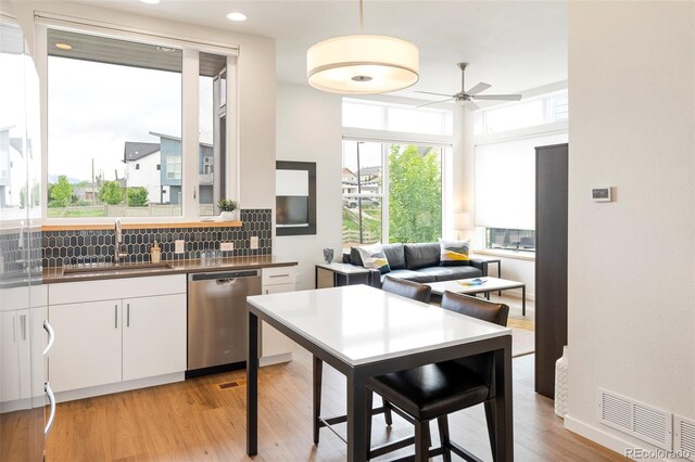928 Cimarron Dr Unit C, Lafayette, CO 80026 - kitchen with stainless steel dishwasher, a sink, ceiling fan, dark countertops, and tasteful backsplash