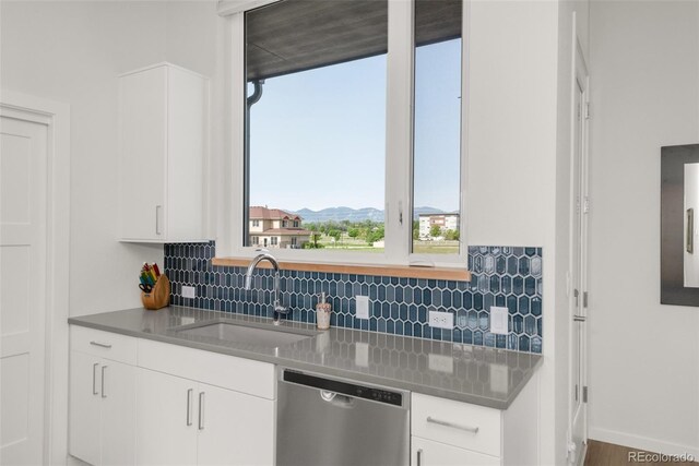 928 Cimarron Dr Unit C, Lafayette, CO 80026 - kitchen with stainless steel dishwasher, a sink, backsplash, and white cabinets