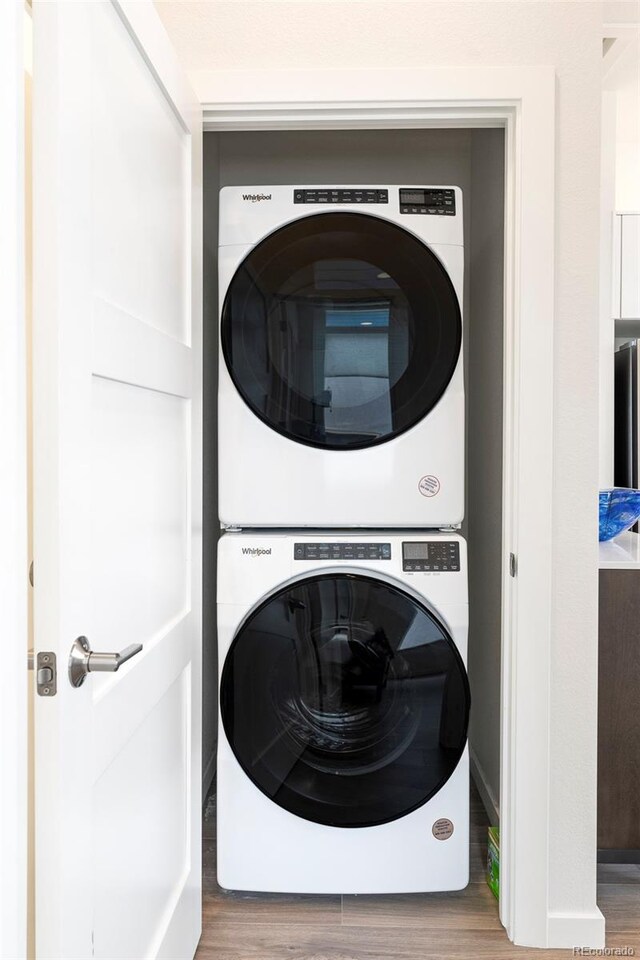 928 Cimarron Dr Unit C, Lafayette, CO 80026 - laundry room with stacked washer / drying machine and wood finished floors