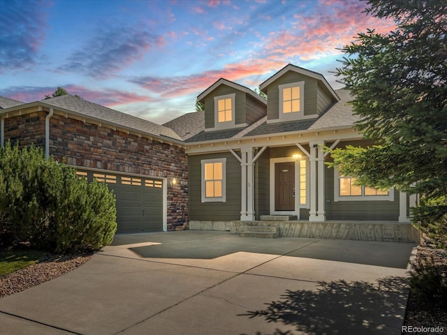 7254 S Kellerman Way, Aurora, CO 80016 - view of front of home with concrete driveway, a garage, stone siding, and a shingled roof
